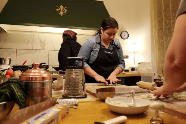 Cooking instructor demonstrating techniques in culinary workshop