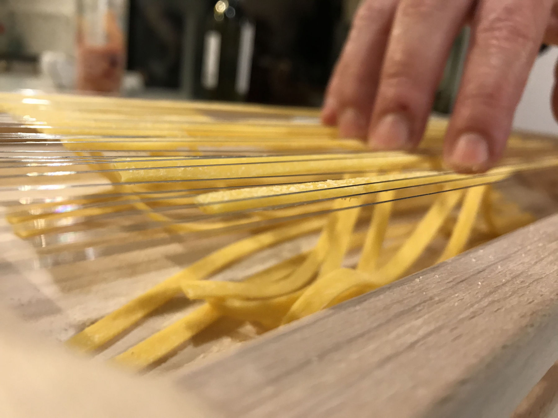 Fresh homemade pasta laid out on wooden cutting board